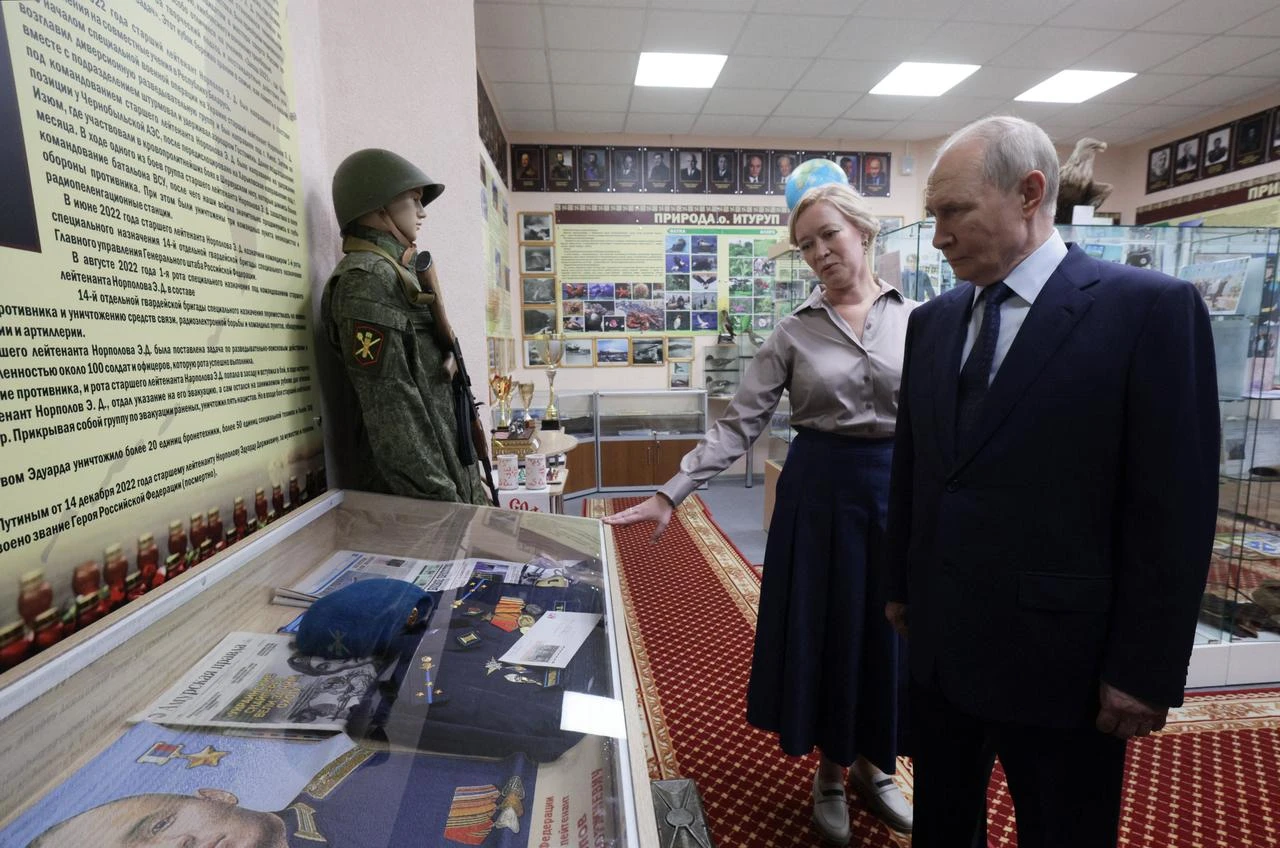 In this pool photograph distributed by the Russian state agency Sputnik, Russia's President Vladimir Putin visits a school on Iturup island, one of four islands in the contested chain known as the Kuril Islands in Russia and the Northern Territories in Japan, on August 13, 2026. (Photo by Gavriil Grigorov / POOL / AFP)