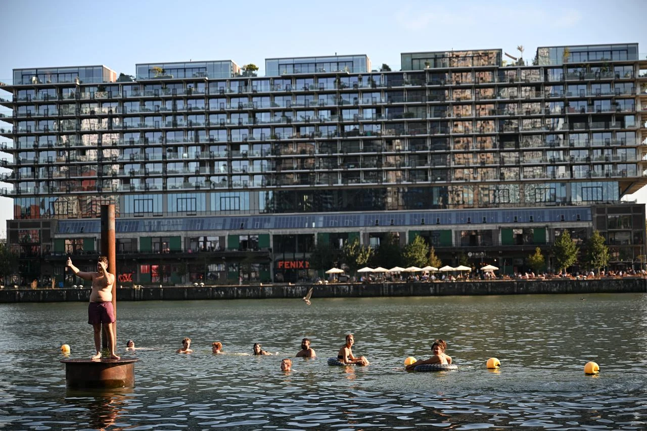 People swim in an urban waterfront to cool off during a heat wave in the Netherlands, Aug. 13, 2026. (AA Photo)