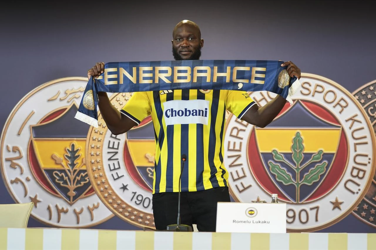 Fenerbahce’s new signing poses with a club scarf during his presentation in Istanbul, Türkiye, Aug. 14, 2026. (AA Photo)