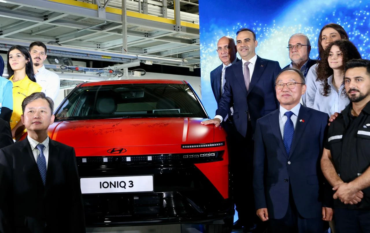 Industry and Technology Minister Mehmet Fatih Kacir (sixth from right) and Hyundai Motor Türkiye executives pose with the fully electric IONIQ 3 during a mass production launch ceremony at Hyundai’s Izmit plant in Kocaeli, Türkiye, Aug. 14, 2026. (AA Photo)