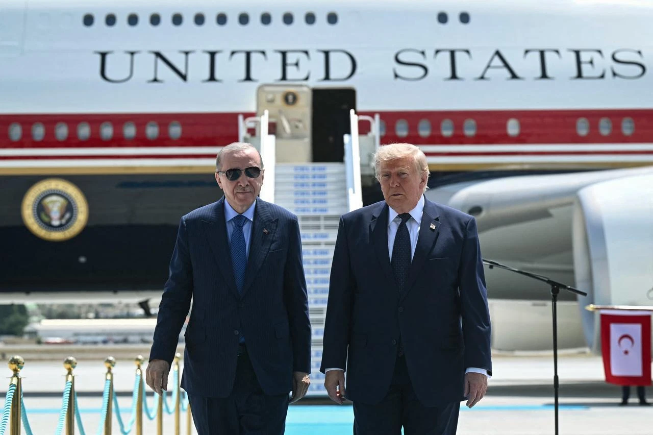 President Recep Tayyip Erdogan (L) welcomes US President Donald Trump (C) upon his arrival on Air Force One at Etimesgut Air Base near Ankara, Türkiye, on July 7, 2026. (AFP Photo)