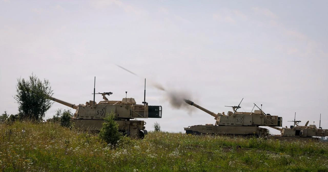 U.S. Army M109 Paladins fire a round during a live fire exercise at Bemowo Piskie Training Area, Poland, Aug. 4, 2026. (Photo via U.S. Army Reserve)