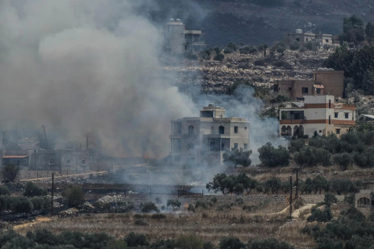 A photograph taken from the southern Lebanese village of Qabrikha shows smoke rising from burning fields in the village of Bani Hayyan, under the control of the Israeli military, about 10 kilometers from the Lebanon-Israel border on August 14, 2026. (AFP Photo)