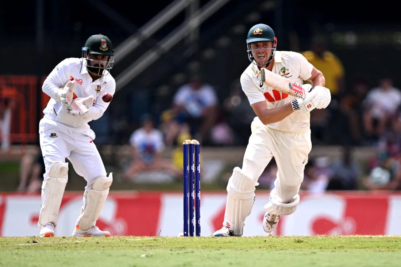 Australia's Cameron Green (R) plays a shot as Bangladesh wicketkeeper Litton Das (L) looks on during the fourth day of the first cricket Test match between Australia and Bangladesh at Marrara Stadium in Darwin on August 16, 2026. (AFP Photo)