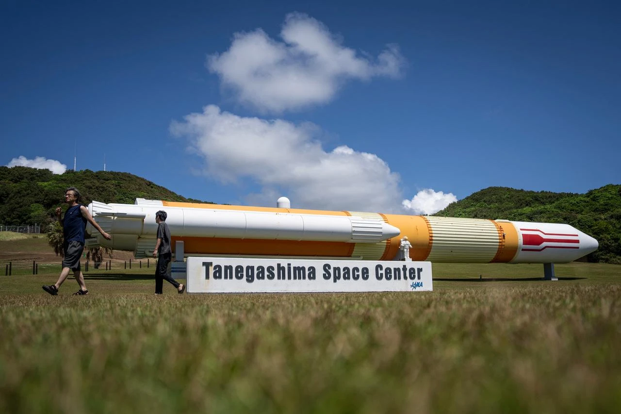 People walk past a full-size model of the H-II launch vehicle at the Tanegashima Space Center in Minamitane, Kagoshima Prefecture, on August 13, 2026. (AFP Photo)