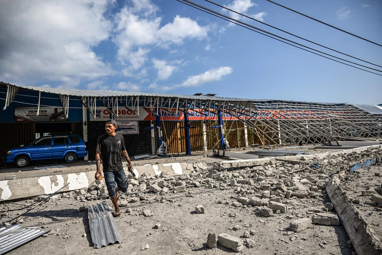 A man walks amid the debris from a damaged building following a 7.7-magnitude earthquake in Borong, East Manggarai, East Nusa Tenggara on August 16, 2026. (AFP Photo)