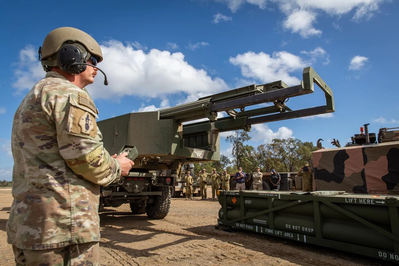 U.S. Army service member prepares the crane for loading the Army Tactical Missile System (ATACMS) onto the High Mobility Artillery Rocket System (HIMARS) in support of Talisman Saber 2023 at Williamson Airfield in Queensland, Australia, July 26, 2023. (Photo via U.S. Army)