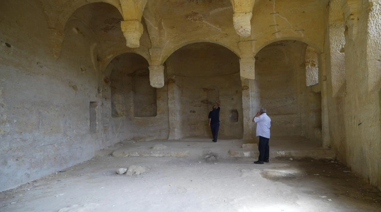 Visitors examine the rock-cut interior of the centuries-old Cakirkaya Monastery in the Siran district of Gumushane, northeastern Türkiye. (IHA Photo)