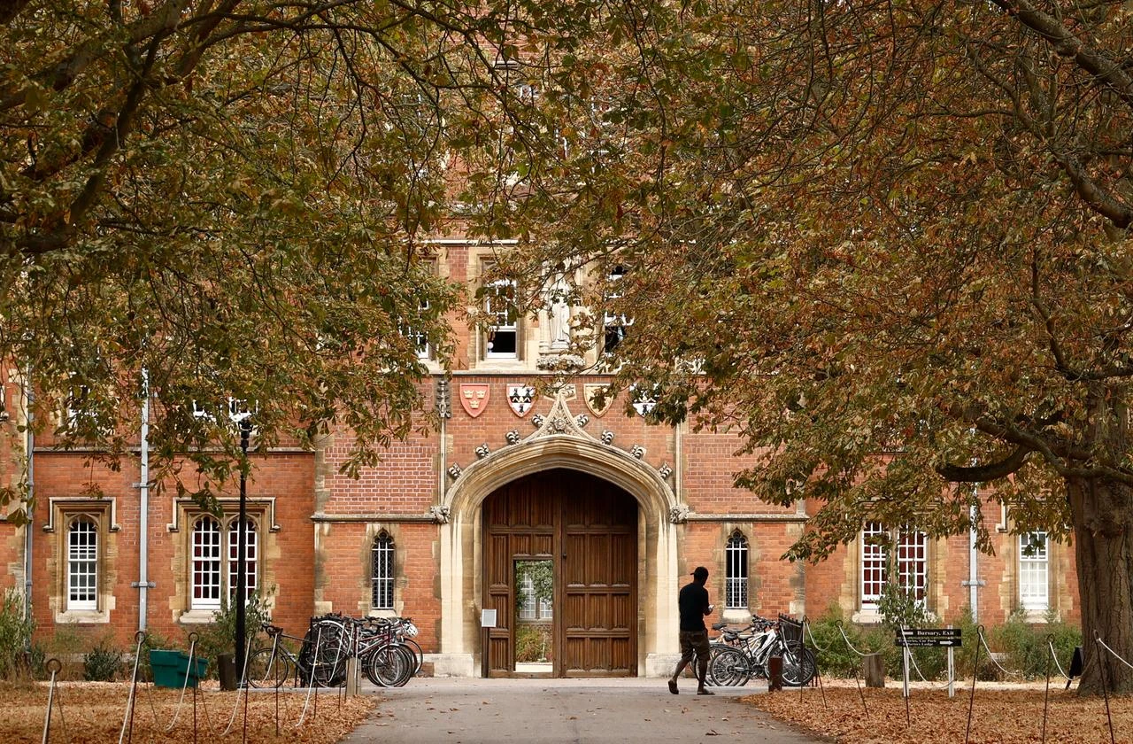 A person walks past Jesus College, where black academic Jason Arday was a Fellow, at the University of Cambridge in Cambridge, eastern England, on August 15, 2026. (AFP Photo)