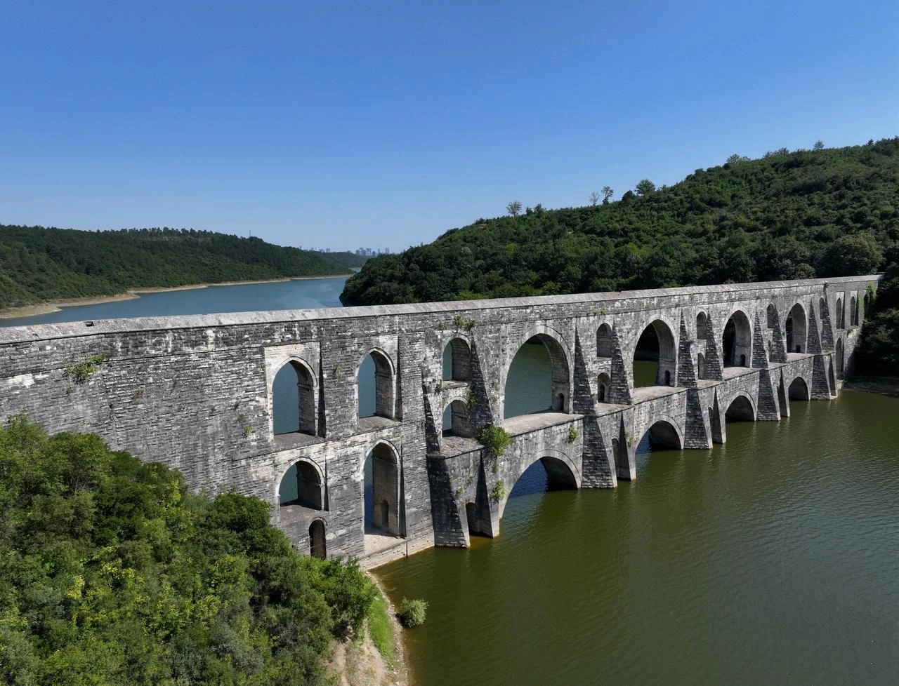 The Maglova Aqueduct, one of Mimar Sinan's most celebrated water-engineering works, spans a reservoir surrounded by forest in Istanbul. (AA Photo)