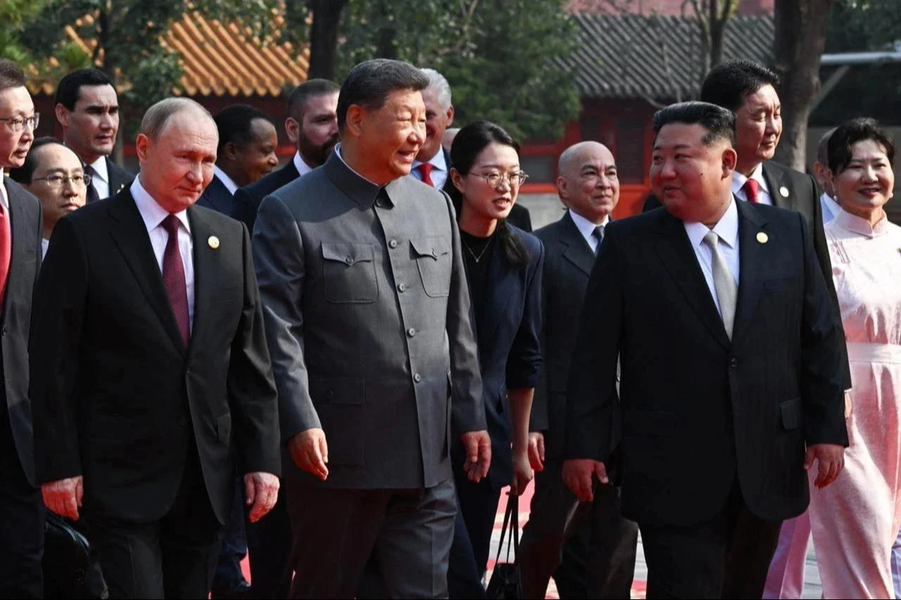 In this pool photograph distributed by the Russian state agency Sputnik, (L-R) Russias President Vladimir Putin walks with Chinas President Xi Jinping and North Koreas leader Kim Jong Un before a military parade marking the 80th anniversary of victory over Japan and the end of World War II, in Beijing’s Tiananmen Square on Sept. 3, 2025. (Photo via Sputnik / AFP)