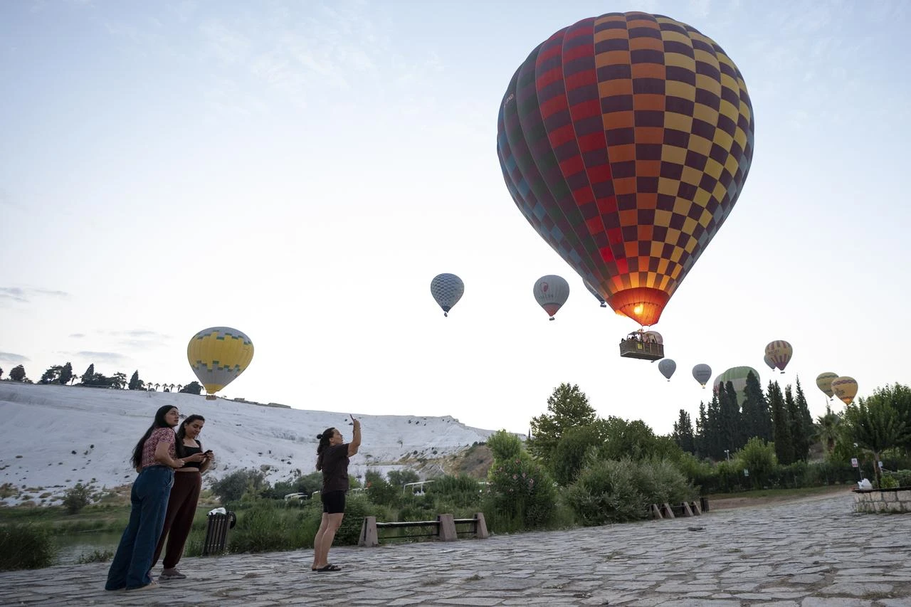 Pamukkale stretches tourism from sunrise balloon rides to night museum visits