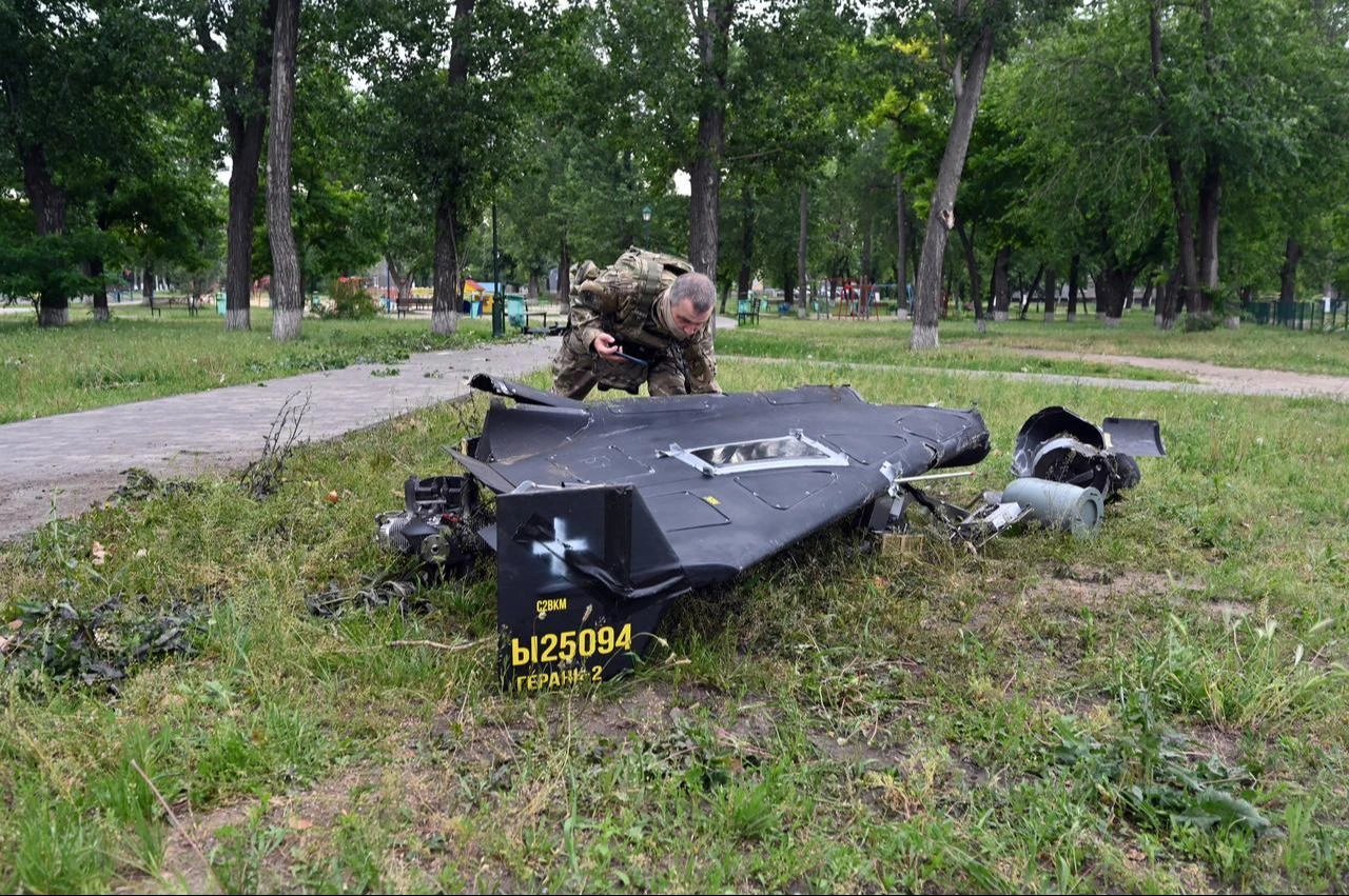 A Ukrainian explosives expert examines parts of a Shahed 136 military drone that fell down following an air-attack in Kharkiv on June 4, 2025. (AFP Photo)