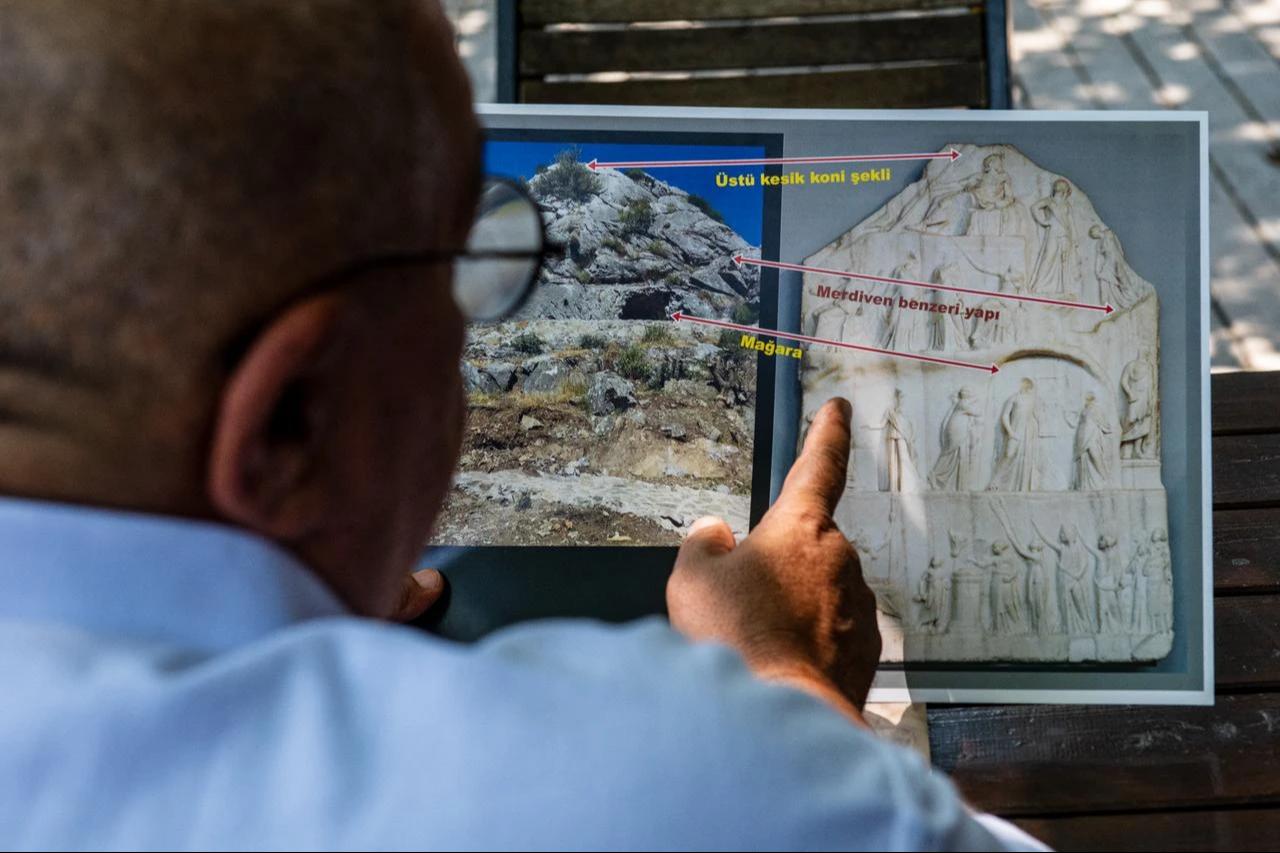 City historian and author Altan Altin points to a stele currently held in the British Museum which he believes depicts a deification ceremony for Homer in Izmir on August 7, 2026. (AFP Photo)