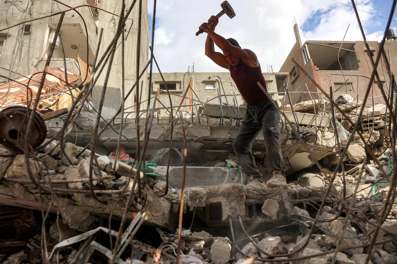 A salvage worker breaks the rubble of a building that was destroyed during Israel's war against Hamas in Gaza, to use the recycled remains in the future, in Gaza City on August 16, 2026. (AFP Photo)