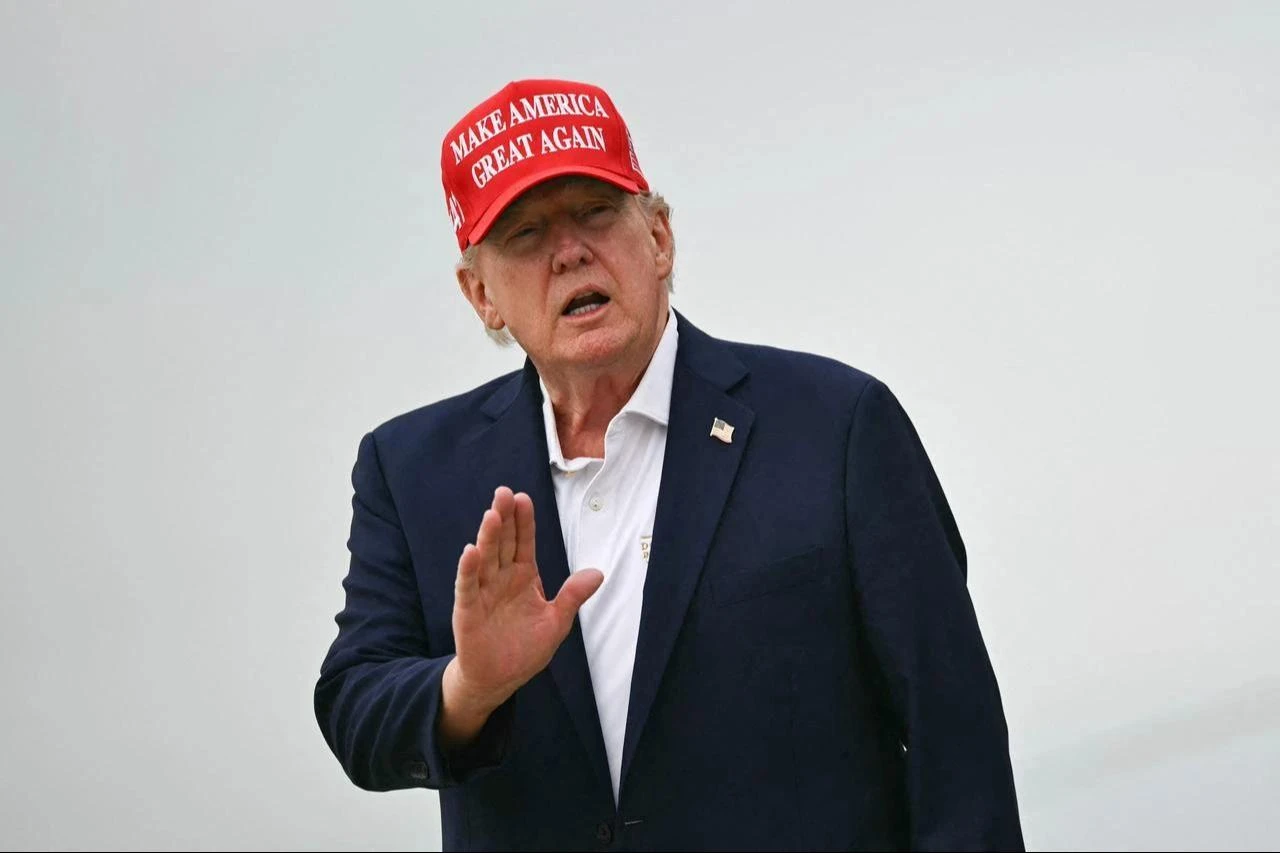 US President Donald Trump gestures as he steps off Air Force One upon arrival at Joint Base Andrews in Maryland on August 16, 2026. (AFP Photo)