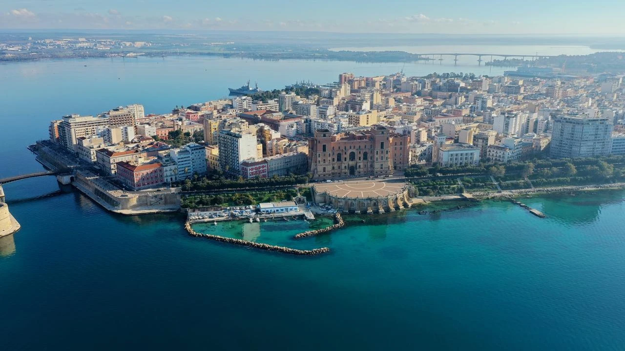 An aerial view shows the coastal city of Taranto surrounded by the Ionian Sea in Puglia, southern Italy. (Adobe Stock Photo)