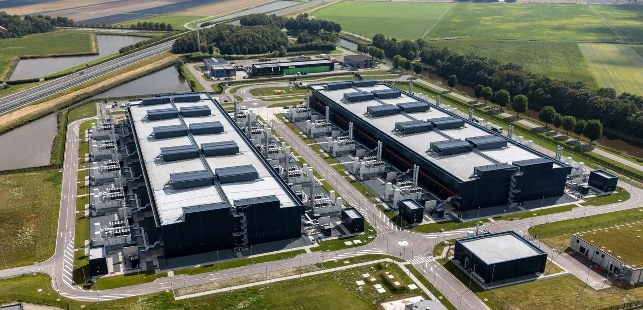 An aerial view of a large data center complex surrounded by farmland and waterways. (Adobe Stock Photo)