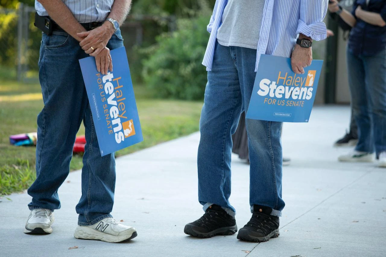 Supporters of U.S. Rep. Haley Stevens (D-MI), candidate for Michigan's open U.S. Senate seat, wait for the Congresswoman to arrive at a canvass launch on July 29, 2026 in Okemos, Michigan. (AFP Photo)