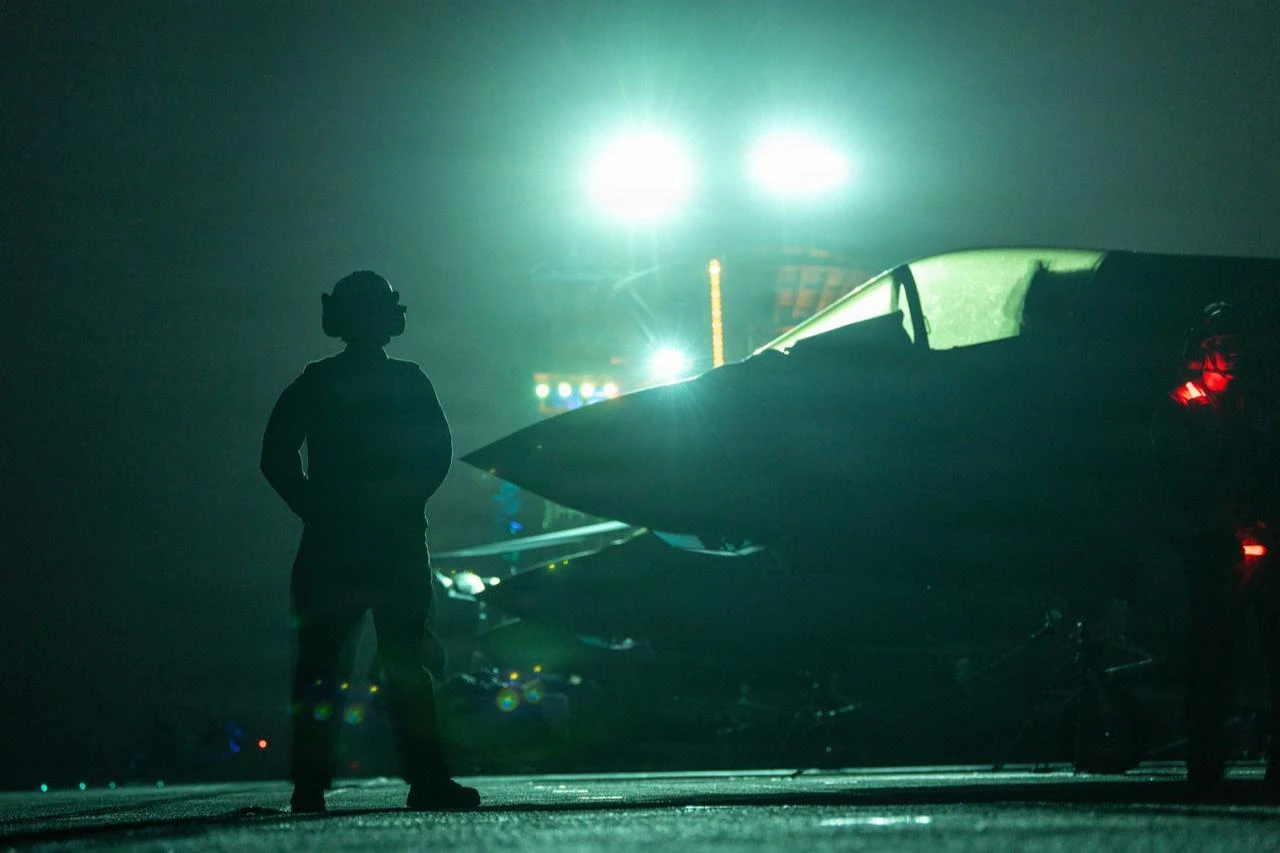 A U.S. Marine supervises flight operations aboard Wasp-class amphibious assault ship USS Boxer (LHD 4) in the U.S. Central Command area of responsibility, July 18, 2026. (Photo via U.S. Marine Corps)