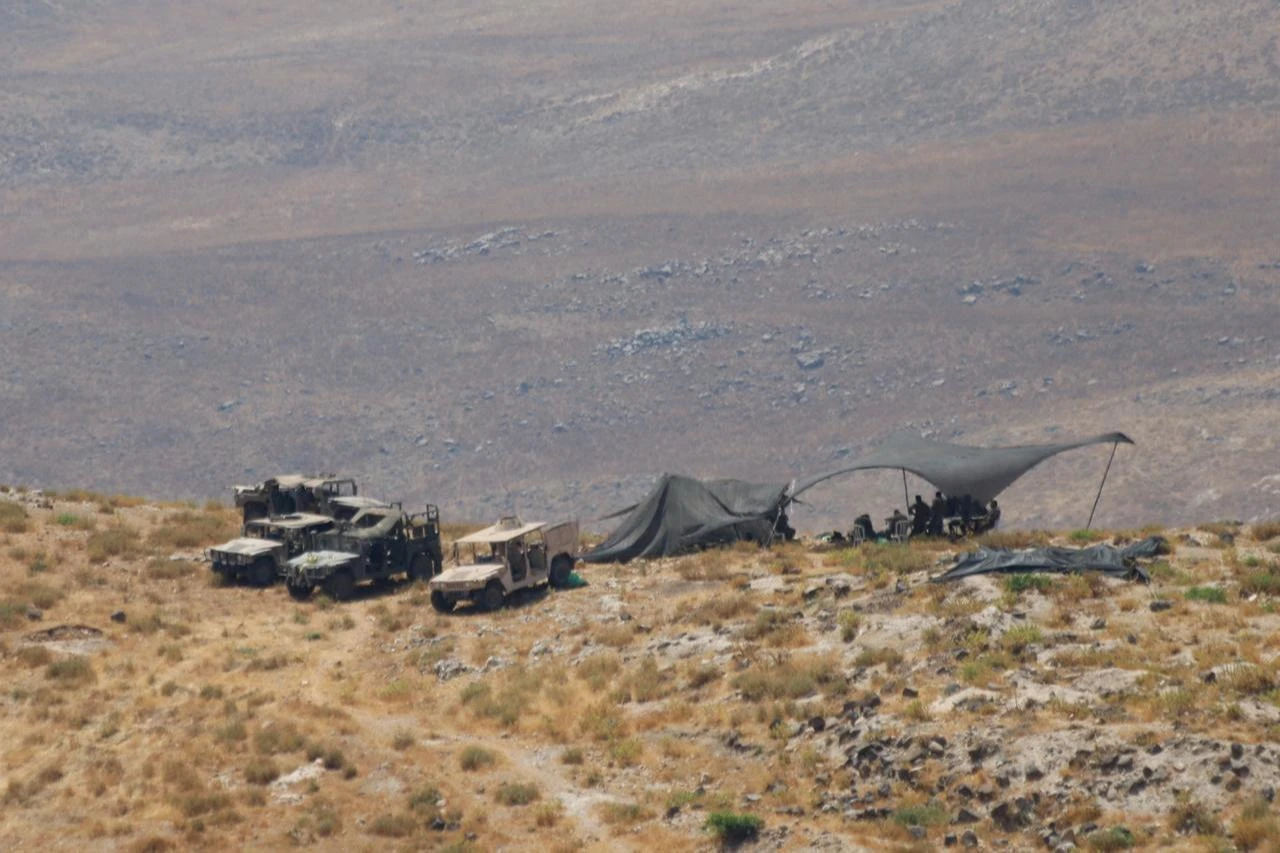 Elements of the Israeli military camp with armored vehicles along the road between the villages of Jamla and Saysoun in the western countryside of the Daraa Governorate in southern Syria, June 28, 2026. (AA Photo)
