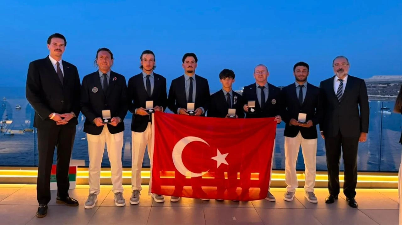 Members of Türkiye’s men’s national golf team pose with their medals and the Turkish flag after the European Team Shield Championships in Malta, Aug. 1, 2026. (AA Photo)