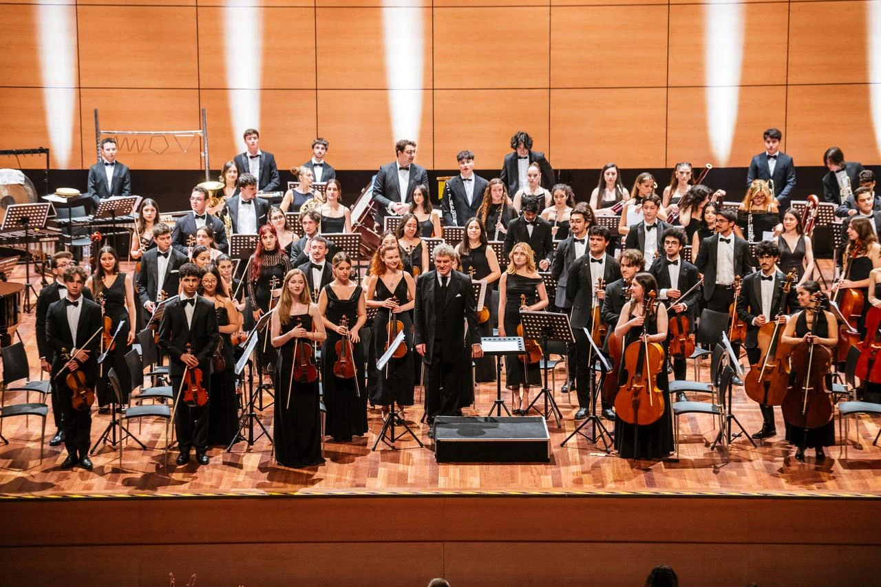 Members of the Türkiye Youth Philharmonic Orchestra pose onstage following their 20th-anniversary concert in Istanbul, Türkiye, Aug. 1, 2026. (AA Photo)