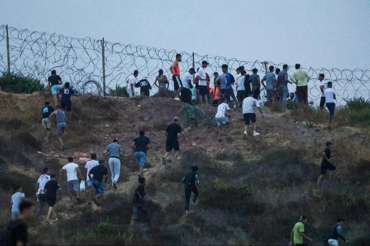 People gather on a hilltop near Bab Sebta on the Morocco-Spain border, near Spain's enclave of Ceuta and the Moroccan town of Fnideq, July 30, 2026. (AFP Photo)