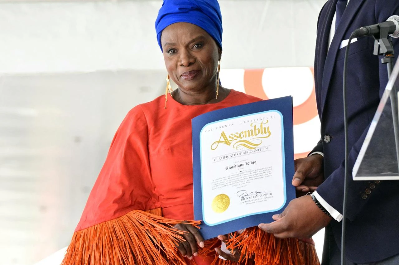 Beninese musician and actress Angelique Kidjo holds a certificate of recognition from the California State Legislature during her Hollywood Walk of Fame star ceremony in the Hollywood neighborhood of Los Angeles on August 18, 2026. (AFP Photo)
