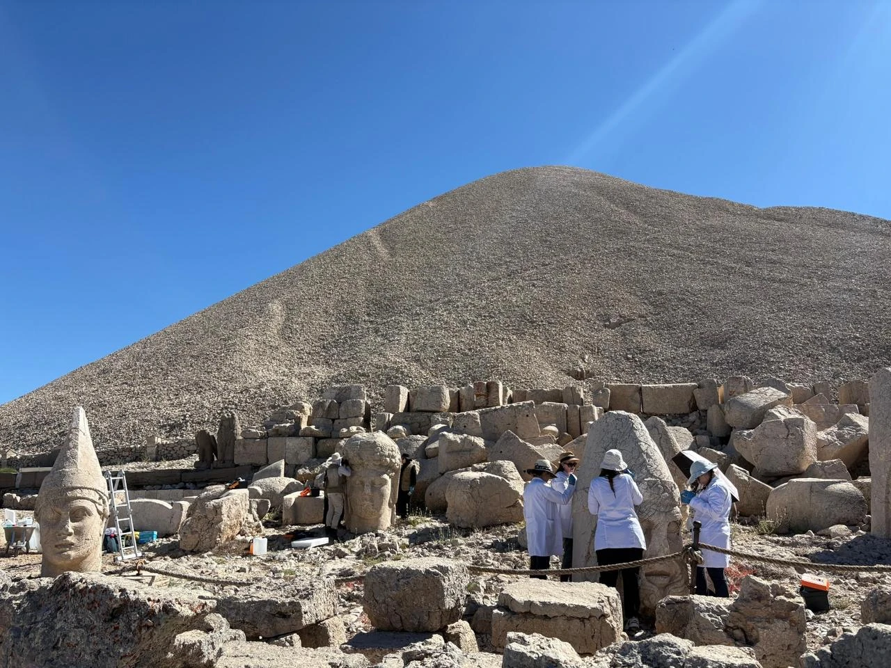 Specialists work among the monumental sculptures and stone remains at Mount Nemrut as part of a five-year conservation program. (Photo via Ministry of Culture and Tourism)