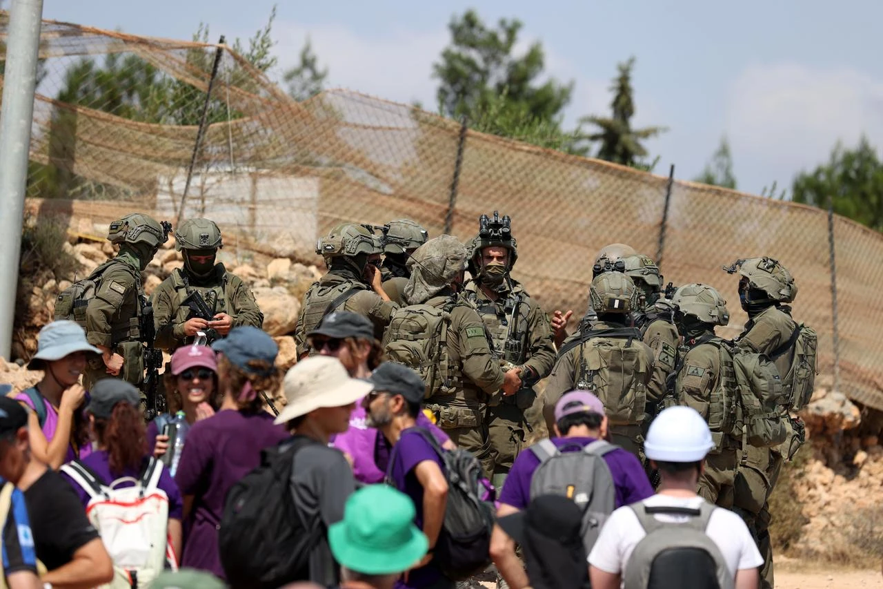 Palestinian, Israeli and foreign activists attempt to deliver basic supplies to three Palestinian families living in the Ras al-Ayn area of Qusra, south of Nablus in the West Bank, Palestine, on August 14, 2026. (AA Photo)