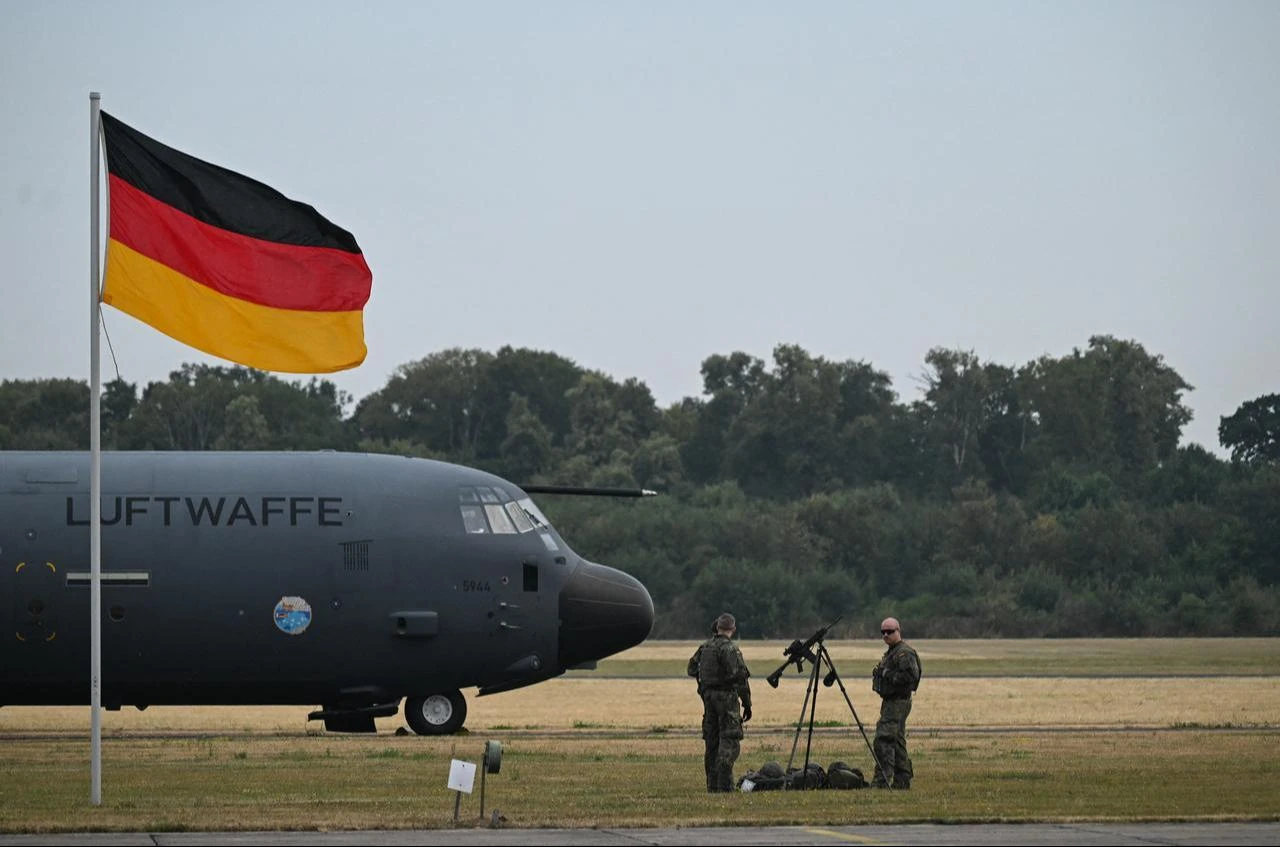 An Airbus A400M four-engine turboprop military transport aircraft of the German forces drives past a German flag at the Noervenich air base in Noervenich, western Germany, July 17, 2026. (AFP Photo)