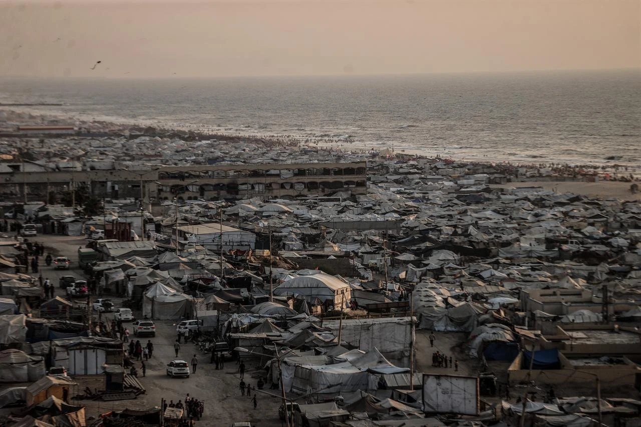 Displaced Palestinians living along the coastal strip of blockaded Gaza City carry out daily activities among the ruins of destroyed buildings during sunset in Gaza, Palestine, Aug. 14, 2026. (AA Photo)