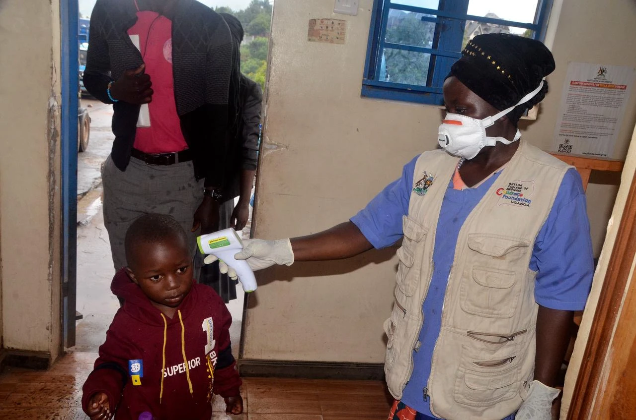 A health worker checks a child’s temperature during Ebola screening at the Mpondwe Border Crossing in Uganda, May 23, 2026. (AA Photo)
