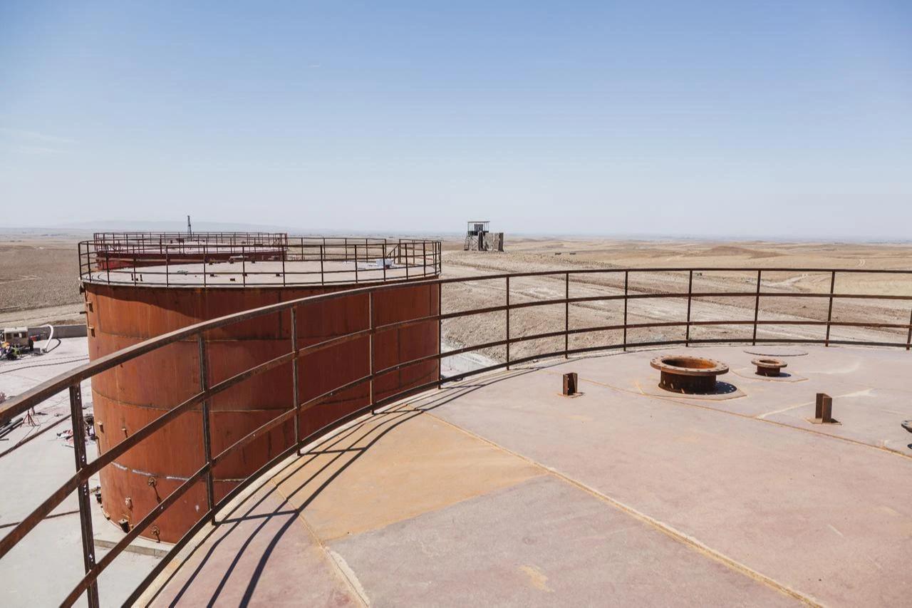 Oil storage tanks stand at an oil field in Iraq. (Adobe Stock Photo)