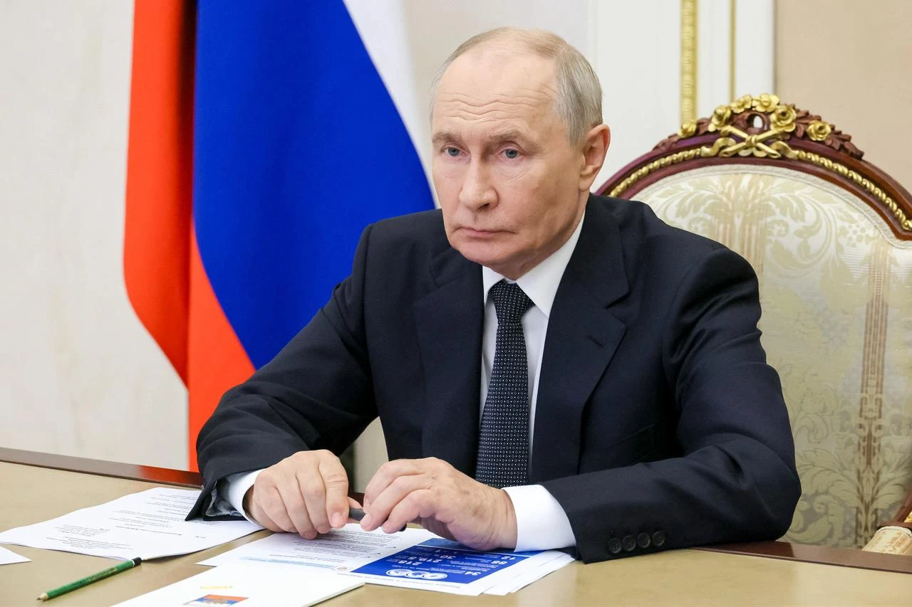 In this pool photograph distributed by the Russian state agency Sputnik, Russian President Vladimir Putin holds a meeting via videoconference on the development of nuclear energy in Russia, in Moscow on August 20, 2026. (Photo by Sputnik/AFP)
