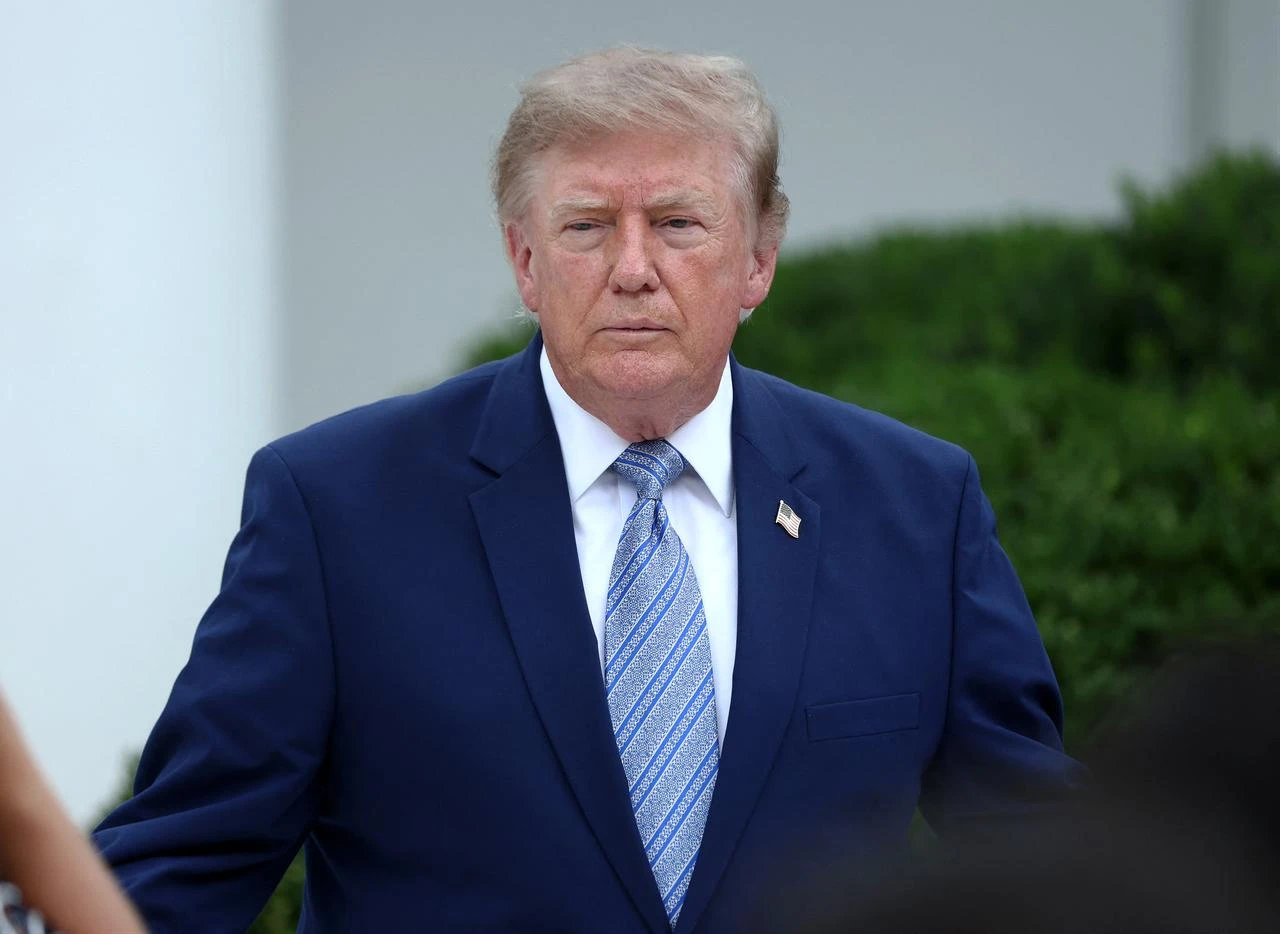 U.S. President Donald Trump (C) speaks with guests during an event announcing the expansion of a foster care initiative in the Rose Garden of the White House on August 20, 2026 in Washington, DC. (AFP Photo)