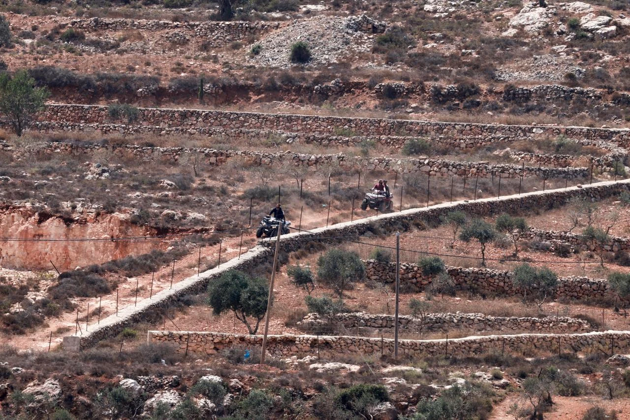 Israeli settlers move around in their off-road vehicles near to the besieged Palestinian houses in Qusra village, south of Nablus, in the occupied West Bank on August 17, 2026. (AFP Photo)