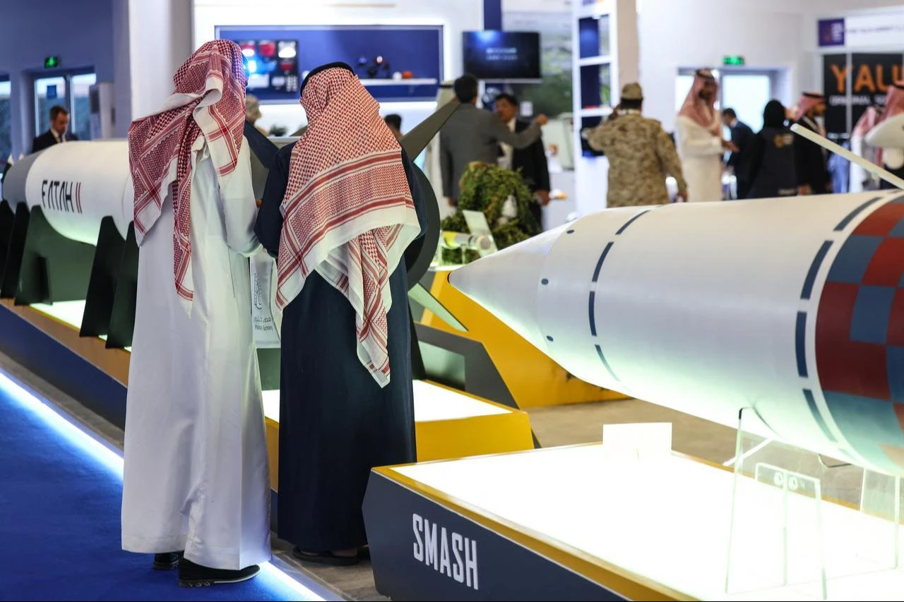 Visitors stand in front of a Fatah-II guided rocket (L) and an SMASH anti-ship missile during the World Defense Show in Riyadh on February 9, 2026. (AFP Photo)