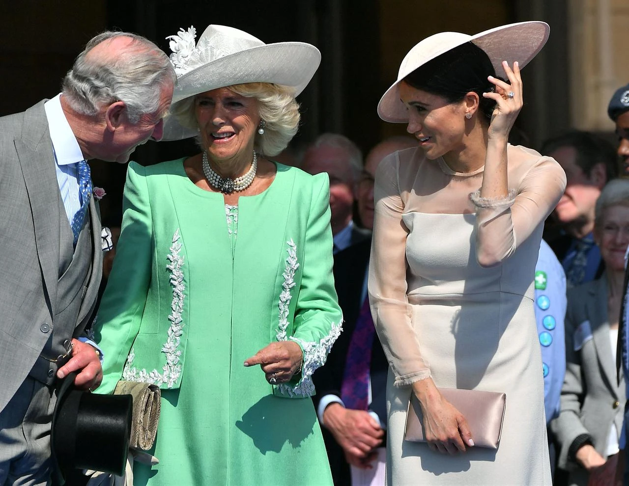 Prince Charles, Prince of Wales (L) and his wife Camilla (C), talk with Meghan as her husband Prince Harry speaks during the Prince of Wales's 70th Birthday Garden Party at Buckingham Palace in London on May 22, 2018.(AFP Photo)