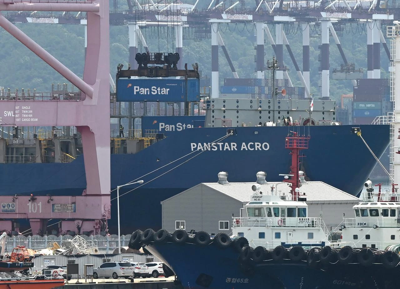 A container is loaded to the container ship "Panstar Acro" at Busan New Port in Busan, South Korea, August 22, 2026. (AFP Photo)