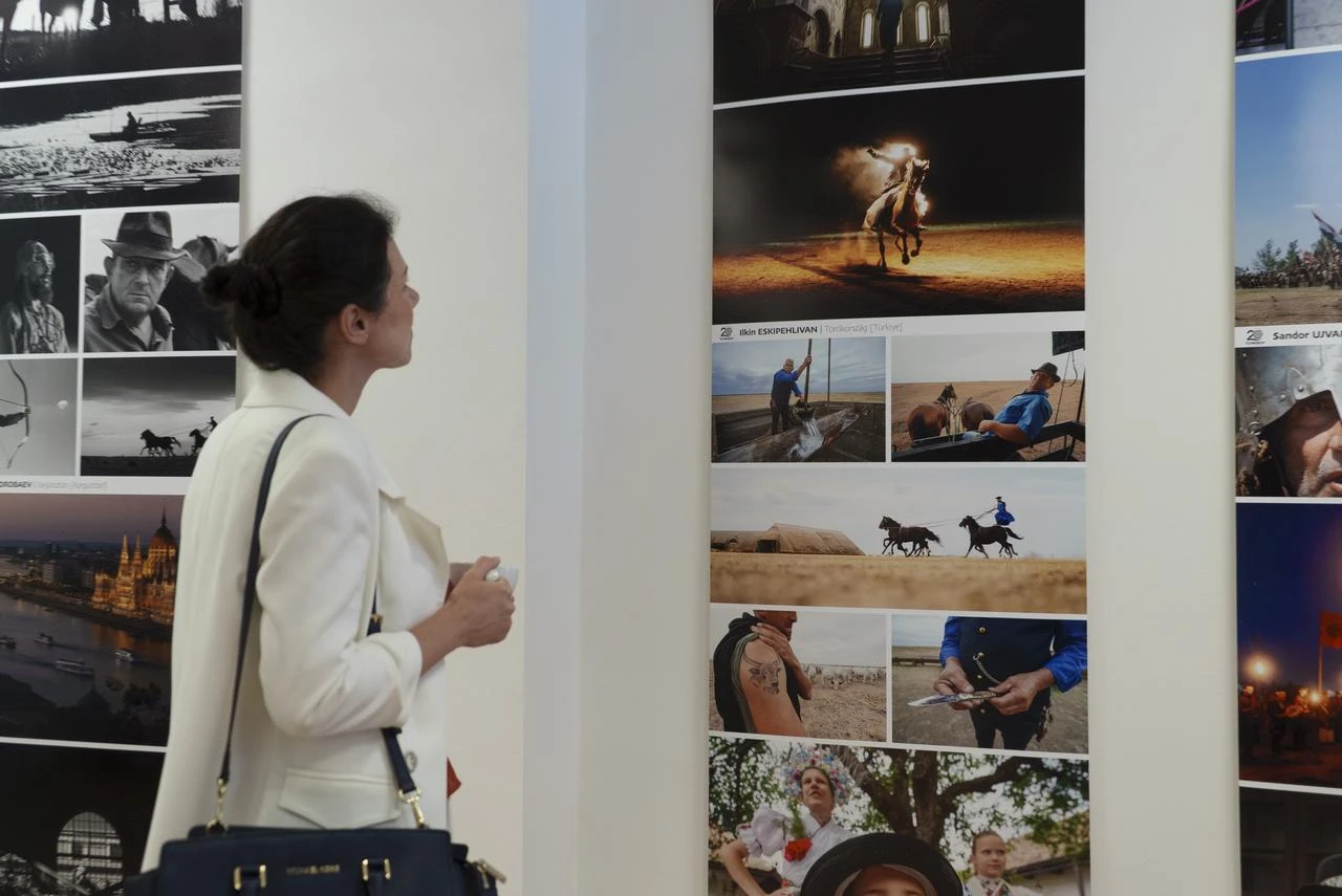 A visitor views photographs by Turkish photographer İlkin Eskipehlivan during the “20th TURKSOY Photographers’ Gathering” jubilee exhibition at the Budapest Art Bridge (BAB) Gallery in Budapest, Hungary, Aug. 22, 2026. (AA Photo)
