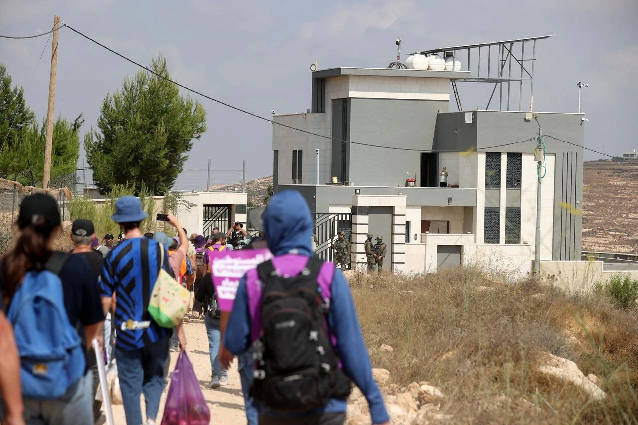 Palestinian, Israeli and foreign activists attempt to deliver basic supplies to three Palestinian families living in the Ras al-Ayn area of Qusra, south of Nablus in the West Bank, Palestine, on August 14, 2026. (AA Photo)