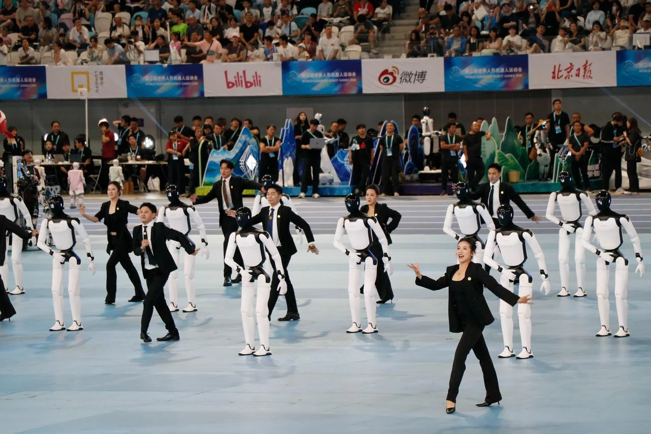 Human performers and humanoid robots take part in the opening ceremony of the second World Humanoid Robot Games at the National Speed Skating Oval in Beijing, China, Aug. 22, 2026. (AA Photo)