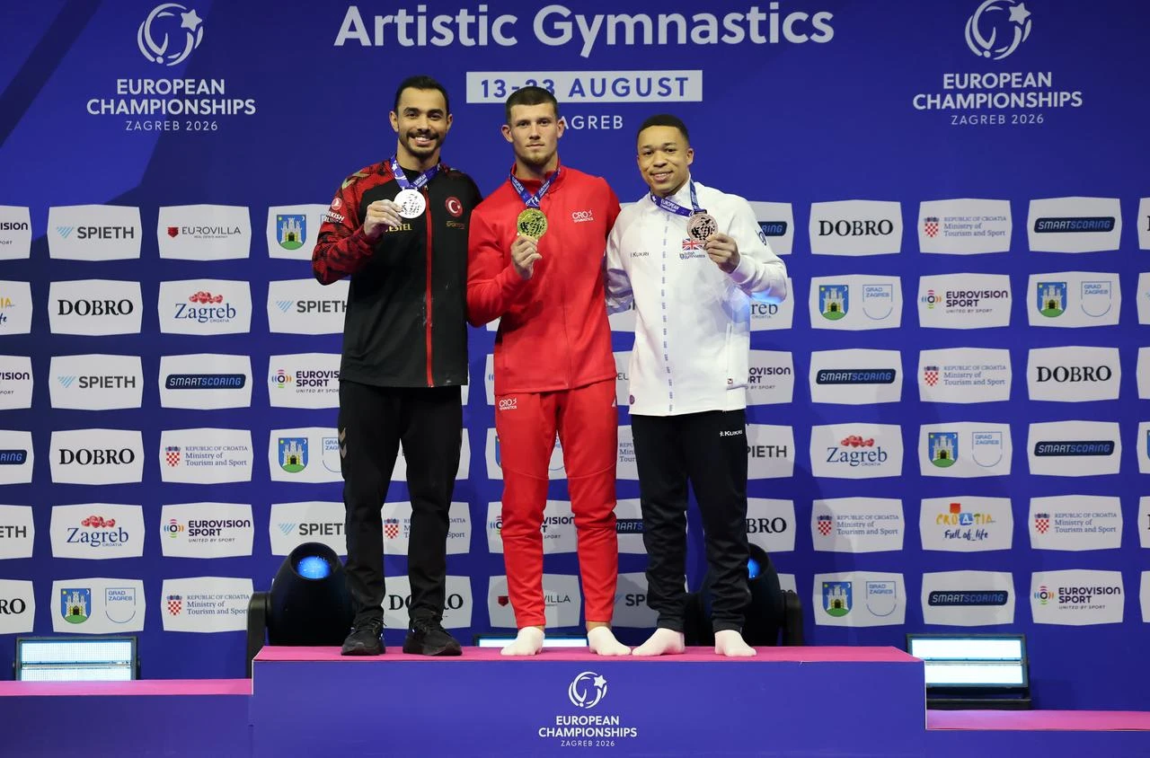 Türkiye’s Ferhat Arıcan (L), Croatia’s Illia Kovtun (C) and Britain’s Joe Fraser pose with their medals after the men’s parallel bars final at the European Artistic Gymnastics Championships in Zagreb, Croatia, Aug. 22, 2026. Arıcan won silver with 14.300 points. (AA Photo)