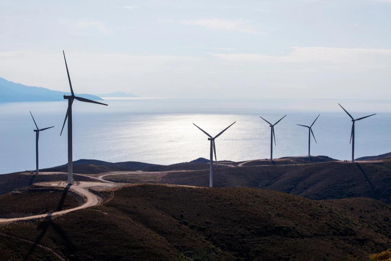 Wind turbines operate along a coast in Türkiye. (Adobe Stock Photo)