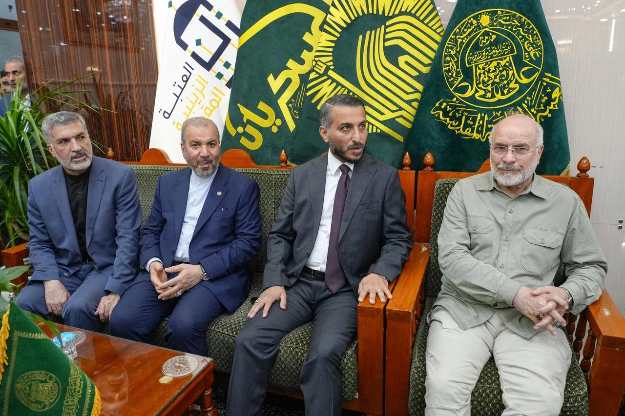 Iran's Parliament Speaker Mohammad Bagher Ghalibaf (R) visits the grave of Abu Mahdi al-Muhandis, a commander of Hashed al-Shaabi, an armed Iraqi alliance that includes pro-Iran groups, at Wadi al-Salam cemetery in the central holy city of Najaf on August 21, 2026. (AFP Photo)
