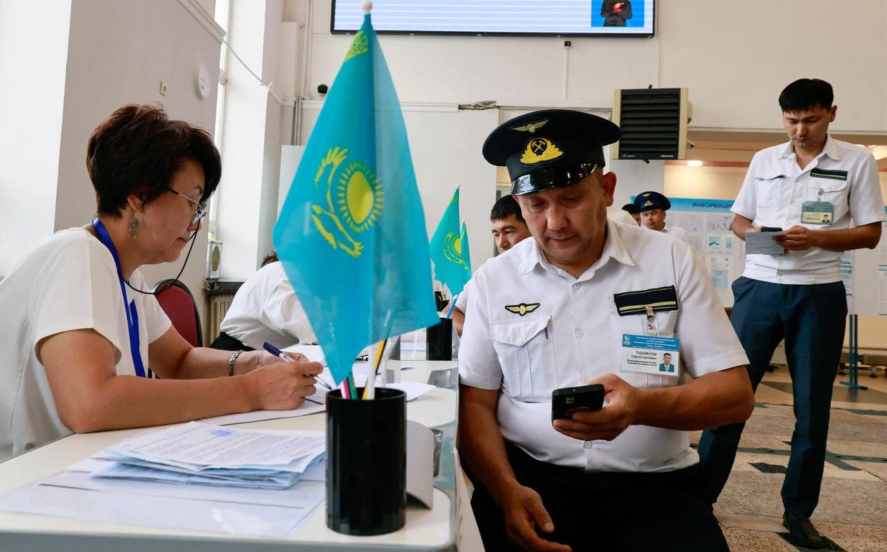 Railroad servicemen receive their ballots at a polling station during parliamentary elections, in Almaty, southeastern Kazakhstan on August 23, 2026. (AFP Photo)