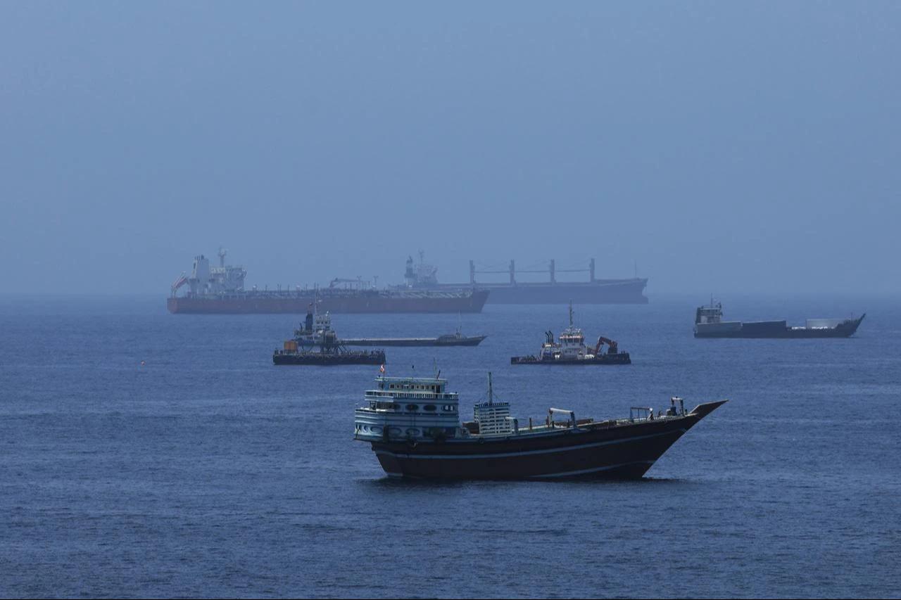 A view of commercial cargo vessels and crude oil tankers are anchored in the Gulf of Oman, off the coast of Muscat, Oman, on June 21, 2026, as they prepare to transit through the critical Strait of Hormuz. (AA Photo)