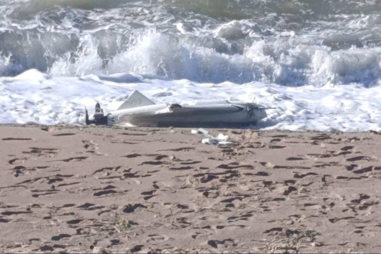 An armed unmanned aerial vehicle lies on the sand at Kapisuyu Beach on the Bartin-Kastamonu provincial border after crashing ashore on the Black Sea coast on June 14, 2026. (IHA Photo)